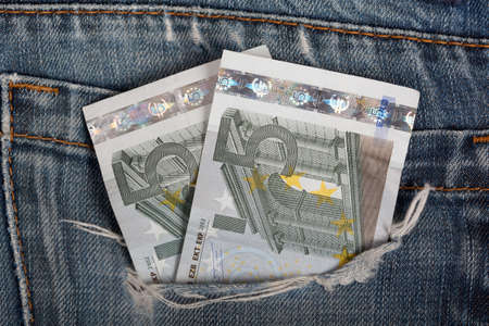 euro bills in jeans