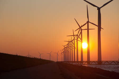 Silhouette of windmills with a sunset の写真素材