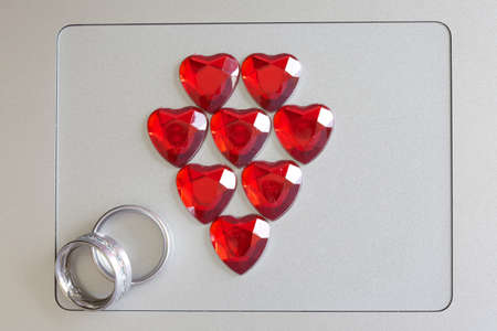 Love symbol and ring on a computerの写真素材