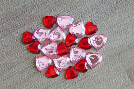 Pendant in the form of red glass heart on a wooden background
