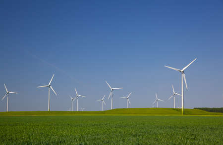 Wind turbines in the farmland with a clear blue sky in the Netherlands