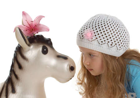 adorable little girl with toy donkeyの写真素材
