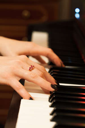 Girls hands playing the pianoの写真素材