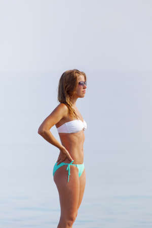 Beautiful young lady in the swimming suit by the oceanのeditorial素材