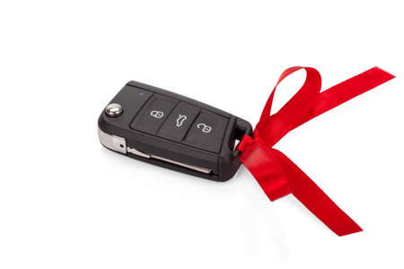 Gift idea: car keys with red ribbon isolated on white 