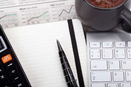 Business photo  tea with open note, pen, calculator, newspaper  stock index overview  and keyboardの写真素材