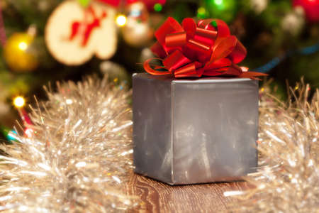 Silver gift box with red ribbon on Christmas festive 