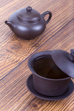 Chinese tea ceremony with ceramic set on wooden table