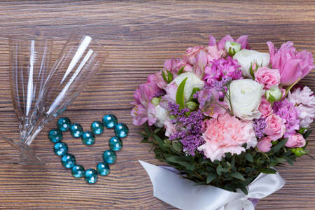 Valentine flowers on with heartshaped jewellery wooden backgroundの写真素材