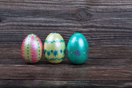 Three Easter eggs on wooden backgorundの写真素材