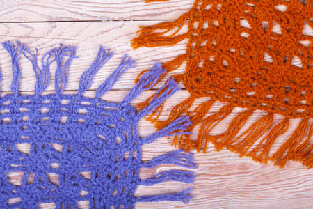 Traditional knitted woolen female shawls on wooden backgroundの写真素材