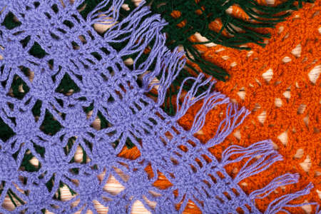 Traditional knitted woolen female shawls on wooden background