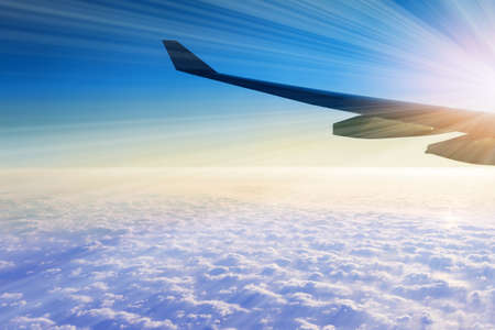 Amazing clouds and the sky as seen through the window of an aircraftの写真素材