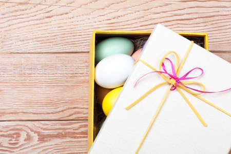 Colorful Easter Eggs decorated in beautiful giftbox with ribbonsの写真素材