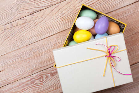 Colorful Easter Eggs decorated in beautiful giftbox with ribbons