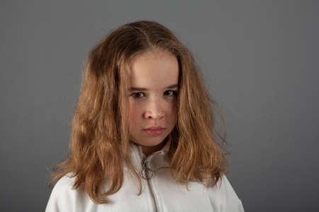 Cute teenage blond girl with sad face