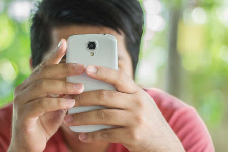 Close up of man using a smart phoneの写真素材