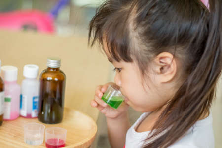 Eating medicine for Illness childの写真素材