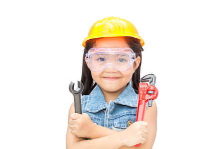 beautiful little girl in helmet with wrench isolated on white  backgroundの写真素材