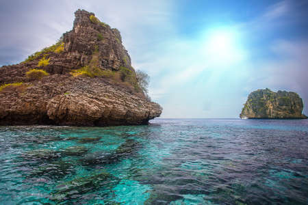 Beautiful tropical beach with big stones and blue skyの写真素材