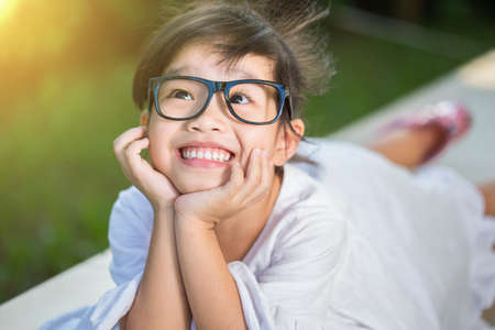Happy little girl having fun at the parkの写真素材