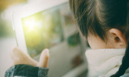 Beautiful asian girl using tablet , early education and learningの写真素材