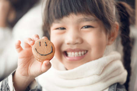 Portrait of beautiful asia Children feel happy eating Bread smiley faceの写真素材