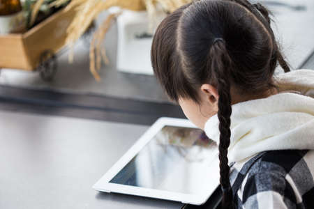 Beautiful asian girl using tablet , early education and learningの写真素材