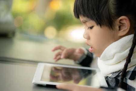 Beautiful asian girl using tablet , early education and learningの写真素材