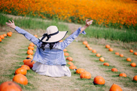 young woman enjoying her time outside in meadow in nature on sunny dayの写真素材