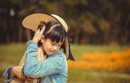 Family,love and happy people concept Mother comforting her crying little girl - parenthood conceptの写真素材