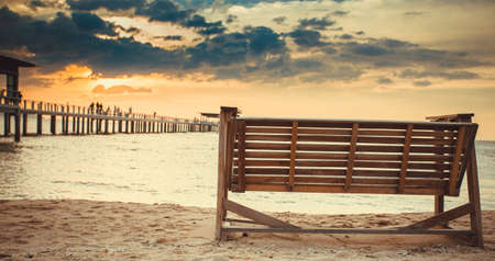 Rocking chairs on the Sand at beach front with blue sky Sunsetの写真素材