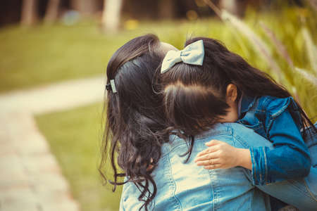 Family,love and happy people concept Mother comforting her crying little girl - parenthood conceptの写真素材