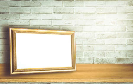 Gold vintage photo frame on White brick wall backgroundの写真素材