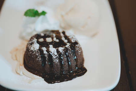Piece of cake with black chocolate syrupの写真素材