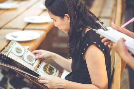 people looking menu waitress taking order restaurantの写真素材