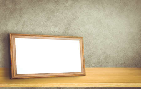Gold vintage photo frame on gray brick wall backgroundの写真素材
