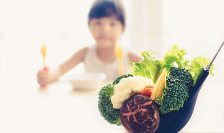 Children like to eat vegetables.の写真素材