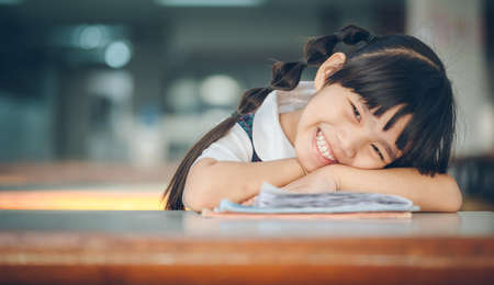 happy schoolgirl , childhood and education concept portrait asia children feeling happy of school girl close up faceの写真素材