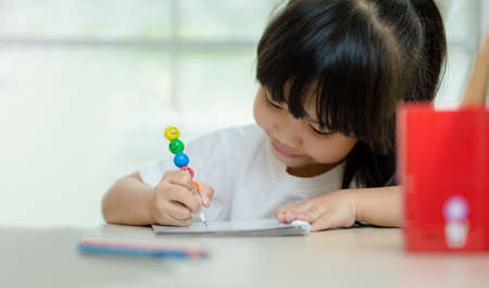 happy schoolgirl , childhood and education concept - happy little girl with chalk drawingの写真素材
