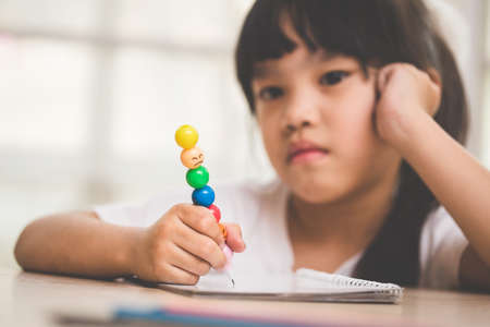 asia girl exasperated with his homeworkの写真素材