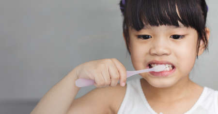 Little asian cute girl brush teethの写真素材