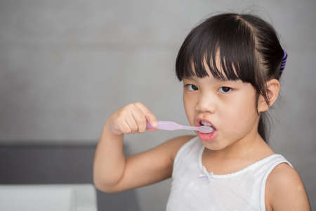 Little asian cute girl brush teethの写真素材