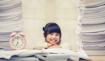 Happy little girl and early education. little kids doing his homework for fun and learningの写真素材