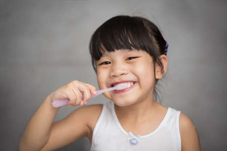 Little asian cute girl brush teethの写真素材