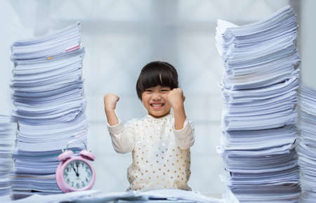 Happy little girl and early education. little kids doing his homework for fun and learningの写真素材