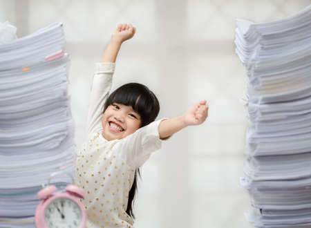 Happy little girl and early education. little kids doing his homework for fun and learningの写真素材