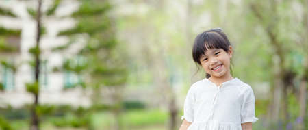Portrait of beautiful asian Children feel happy green backgroundの写真素材