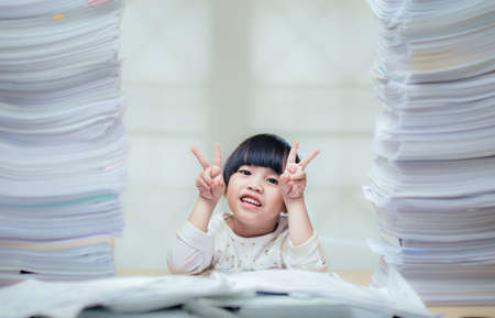 Happy little girl and early education. little kids doing his homework for fun and learning on white backgroundの写真素材