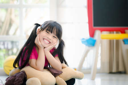Funny kid having fun in kids roomの写真素材